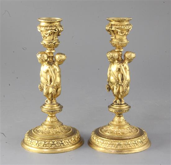 A pair of mid 19th century French ormolu candlesticks, height 8.25in.